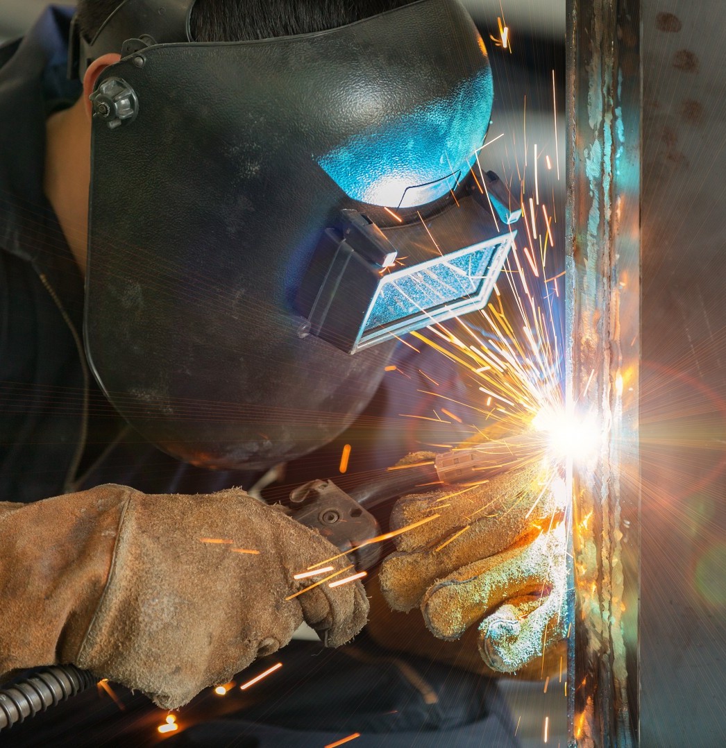 worker welding construction by MIG welding